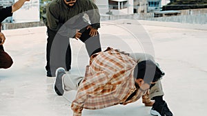 Hispanic break dancer practice B boy dance with friends at roof top. hiphop.