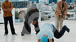 Hispanic break dancer practice B boy dance with friends at roof top. hiphop.