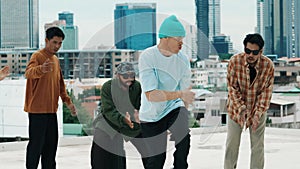 Hispanic break dancer practice B boy dance with friends at roof top. hiphop.