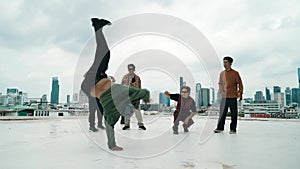 Hispanic break dancer practice B boy dance with friends at roof top. hiphop.