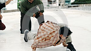 Hispanic break dancer practice b boy dance with friends at roof top. hiphop.