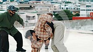 Hispanic break dancer practice b boy dance with friends at roof top. hiphop.