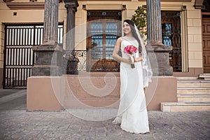 Hispanic bride outside a courthouse