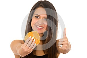 Hispanic brunette model holding up hamburger to