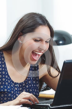 Hispanic brunette office woman sitting by desk and