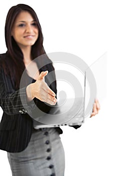 Hispanic business female on laptop geturing a handshake