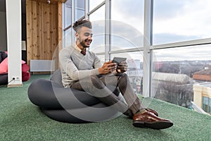 Hispanic Business Man Using Tablet Computer Sit n Front Panoramic Window Happy Smiling Businessman