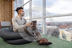 Hispanic Business Man Using Tablet Computer Sit n Front Panoramic Window Happy Smiling Businessman