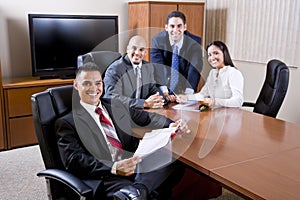 Hispanic business people meeting in boardroom