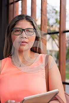 Hispanic business woman outdoors with glasses