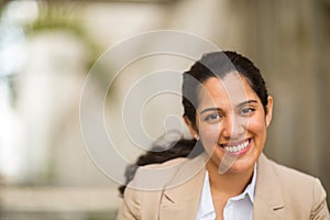 Hispanic business woman smiling outside stock photo