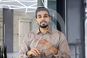 Hispanic businessman engaging in a video call from office