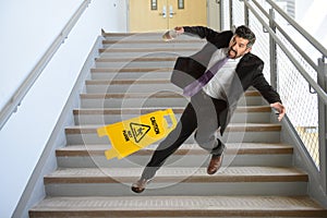 Hispanic Businessman Falling on stairs