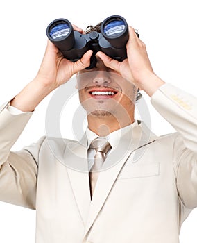 Hispanic businessman looking through binoculars