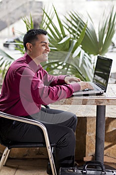 Hispanic Businessman - Telecommuting from Cafe