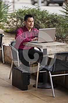 Hispanic Businessman - Telecommuting Internet Cafe photo