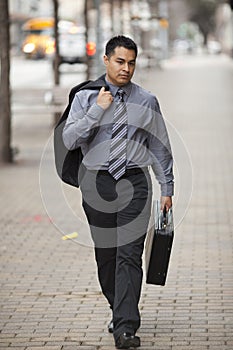 Hispanic Businessman - Walking With Briefcase