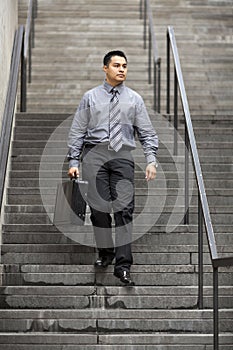 Hispanic Businessman - Walking Down Staircase