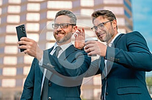 Hispanic businessmen using smartphone at the city. Handsome business men in suit calling mobile phone. Finance news with