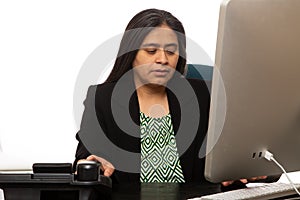 Hispanic Businesswoman Grabs Phone While Typing