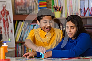 Hispanic Child Completing Puzzle with Mom