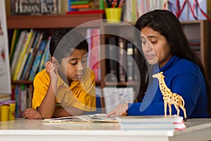 Hispanic Child Learning to Read with Mom