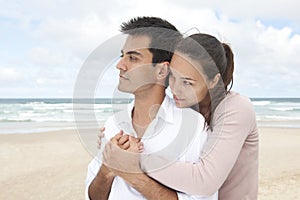 Hispanic couple bonding on beach