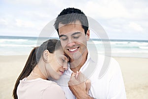 Hispanic couple bonding on beach