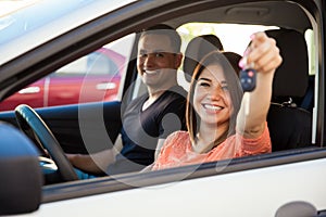 Hispanic couple with a new car