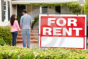 Hispanic couple outside home for rent