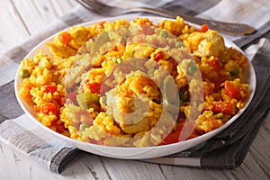 Hispanic cuisine: Arroz con pollo close up in a bowl. Horizontal photo