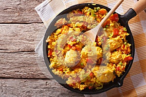 Hispanic cuisine: Arroz con pollo in a pan. horizontal top view