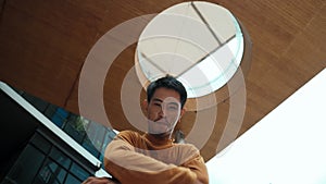 Hispanic dancer looking at camera while dancing at sky scrapper. Endeavor.