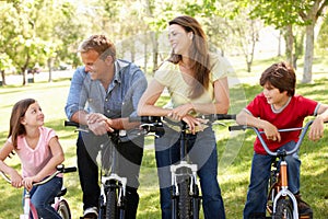 Hispanic family on bikes in park