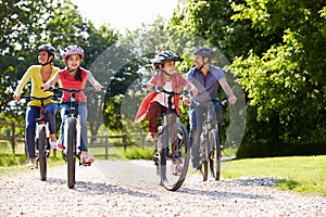 Hispanic Family On Cycle Ride In Countryside