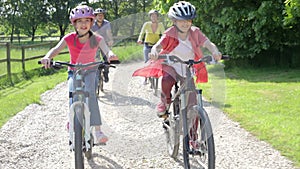 Hispanic Family On Cycle Ride In Countryside