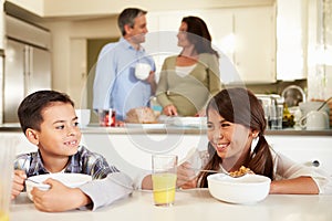 Hispanic Family Eating Breakfast At Home Together