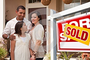 Hispanic Family in Front of New Home and Sold Sign