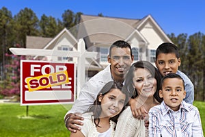 Hispanic Family in Front of Sold Real Estate Sign, House