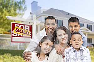 Hispanic Family in Front of Sold Real Estate Sign, House