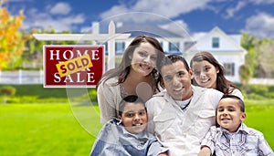 Hispanic Family in Front of Sold Real Estate Sign, House