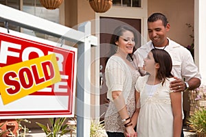 Hispanic Family in Front of Their New Home