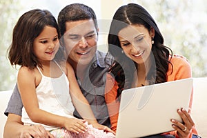 Hispanic family with laptop at home