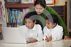 Hispanic Family with Laptop in Home-school Environment