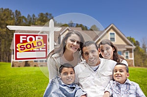 Hispanic Family New Home and Sold Real Estate Sign