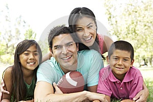 Hispanic Family In Park With Soccer Ball