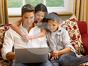 Hispanic father and children shopping online