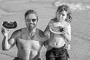 hispanic father and son kid enjoying the sea in fatherhood. Father dad and son eating watermelon. dad father and son on