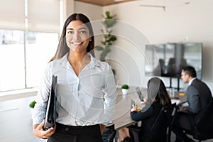 Hispanic female business professional in office boardroom