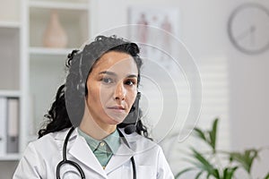 Hispanic female doctor in consultation via headset